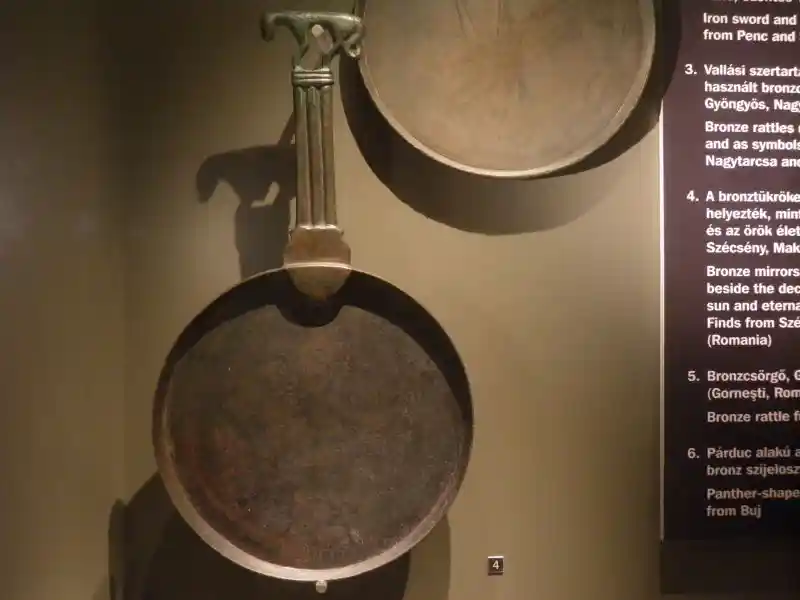 Bronze mirror, a solar symbol with an animal on the handle